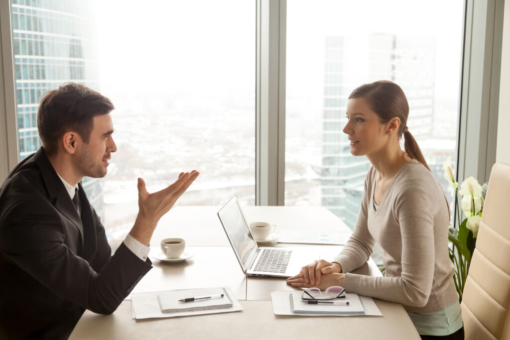 businessman-businesswoman-having-face-to-face-discussion